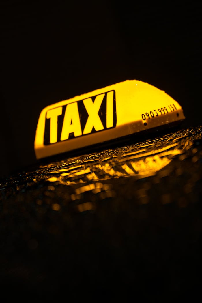 gallery-img-02 A glowing taxi sign reflected on a wet surface at night in Bratislava, Slovakia.