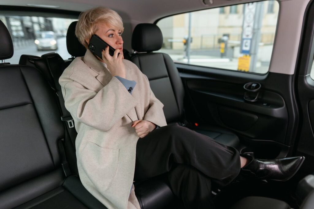 pexels photo 7222318 Woman in a car making a phone call, wearing a coat and resting comfortably.